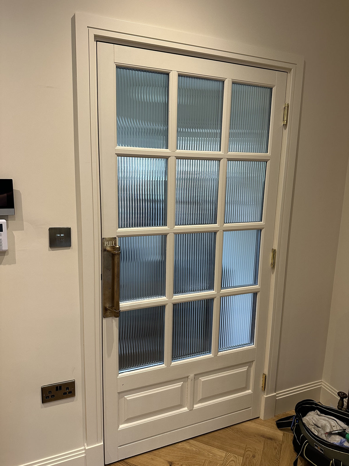 An internal multi pane door with reeded window film applied to the individual sections.