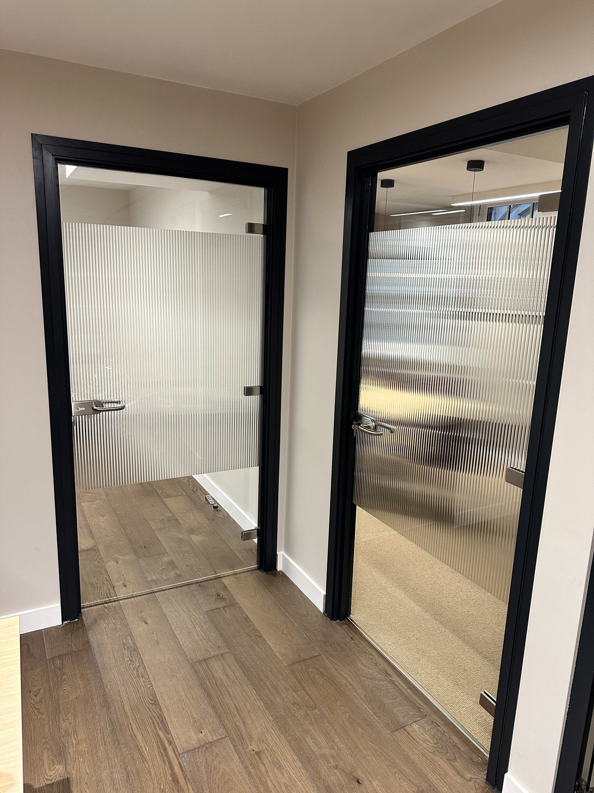Evoke reeded window film applied to two glazed doors in an office.  The window film is for privacy and glass decoration.