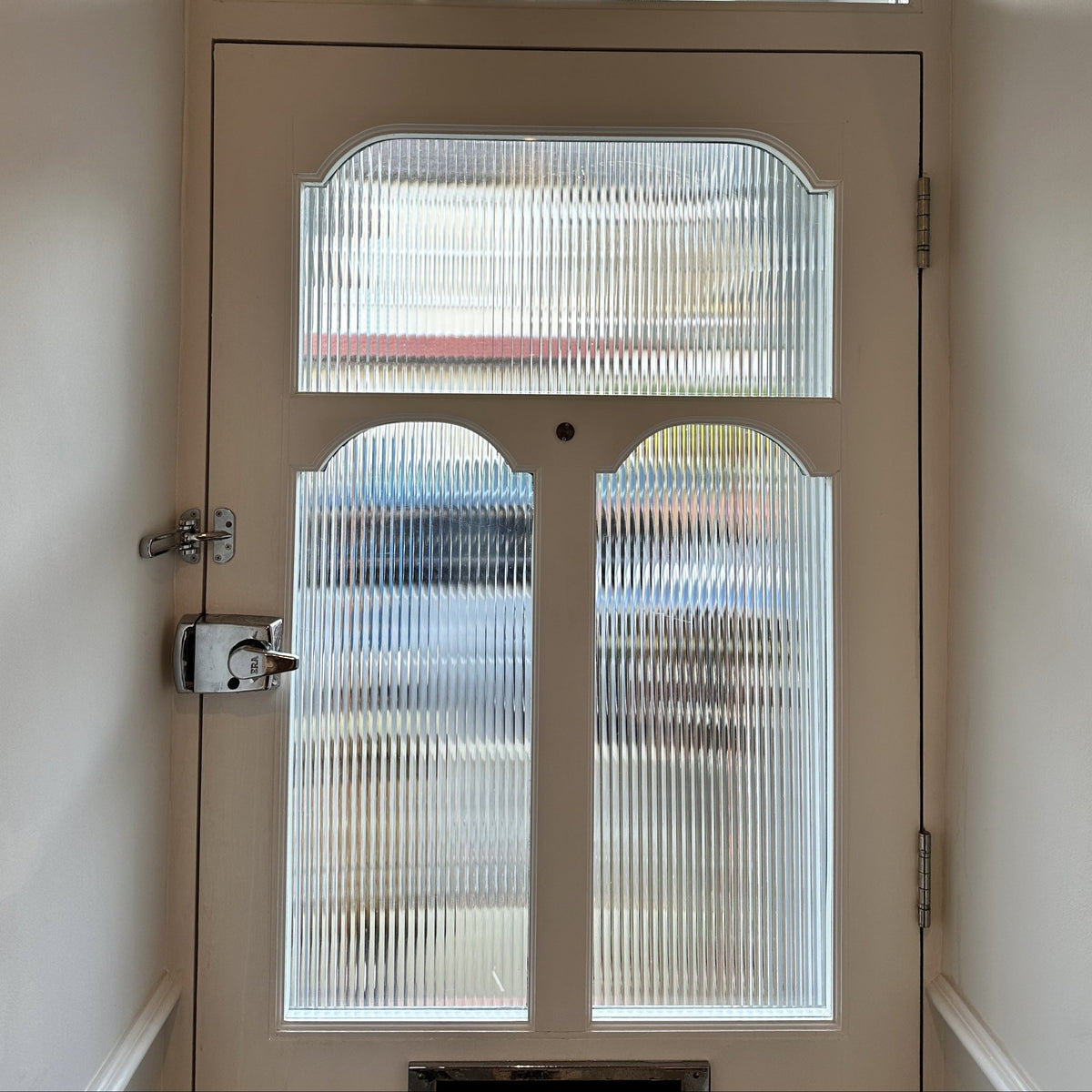 Evoke reeded window film applied to the glass in a front door for decorative style and privacy.