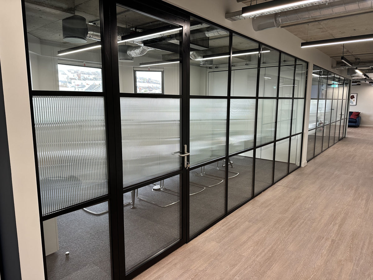 Evoke reeded window film applied to the central row of glazing within an office partition.