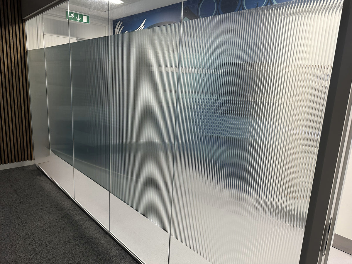 Evoke reeded window film applied to an internal glass partition as part of an office fit out.