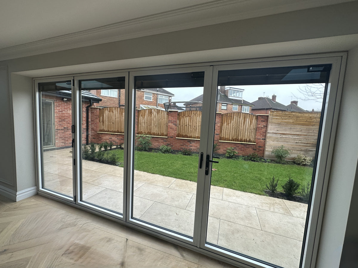 Clear safety window film applied to patio bifold doors.