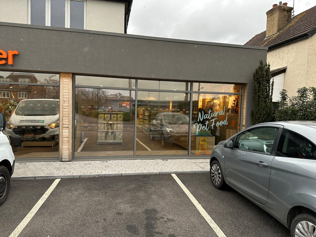 A glass store front that has a solar control film applied to the large panes of glass to help reduce heat and UV rays.