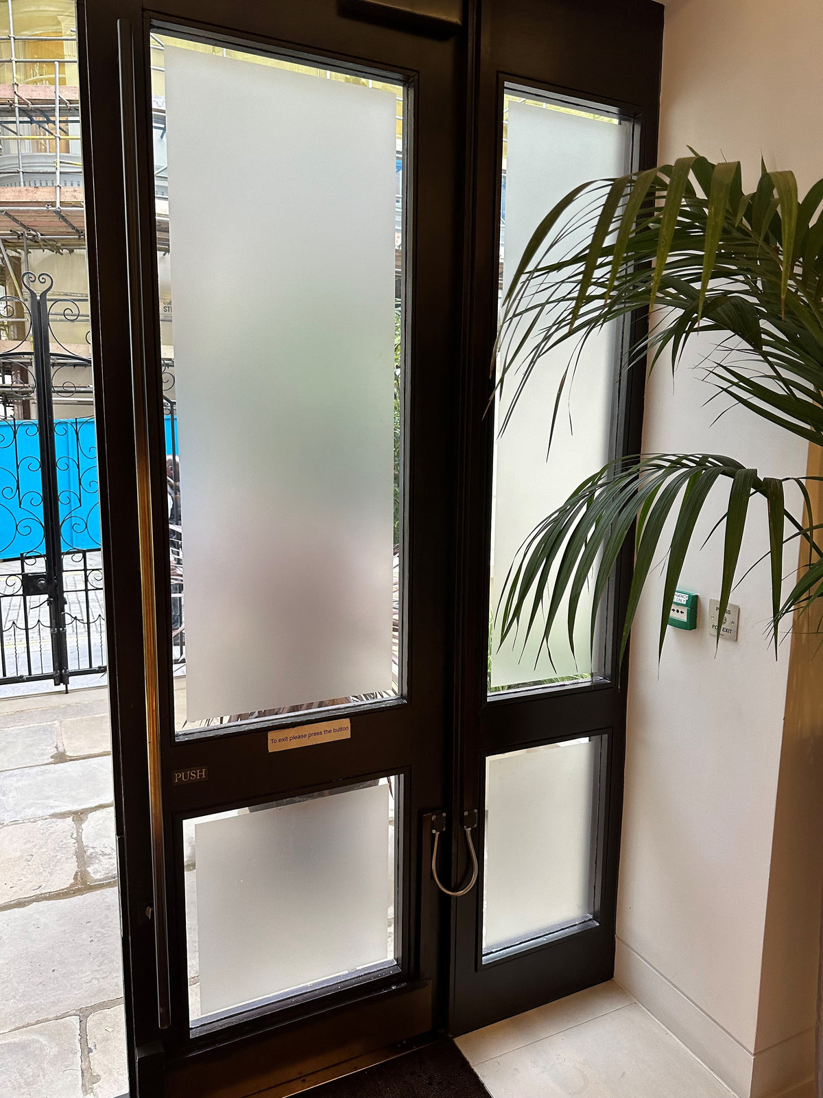 Double glass doors with frosted window film applied to the four glazed panels in a home setting