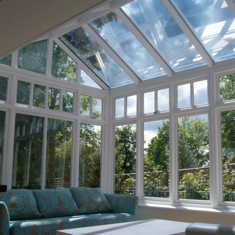 Modern conservatory with glass roof which has had solar film applied to educe the excess heat and glare.