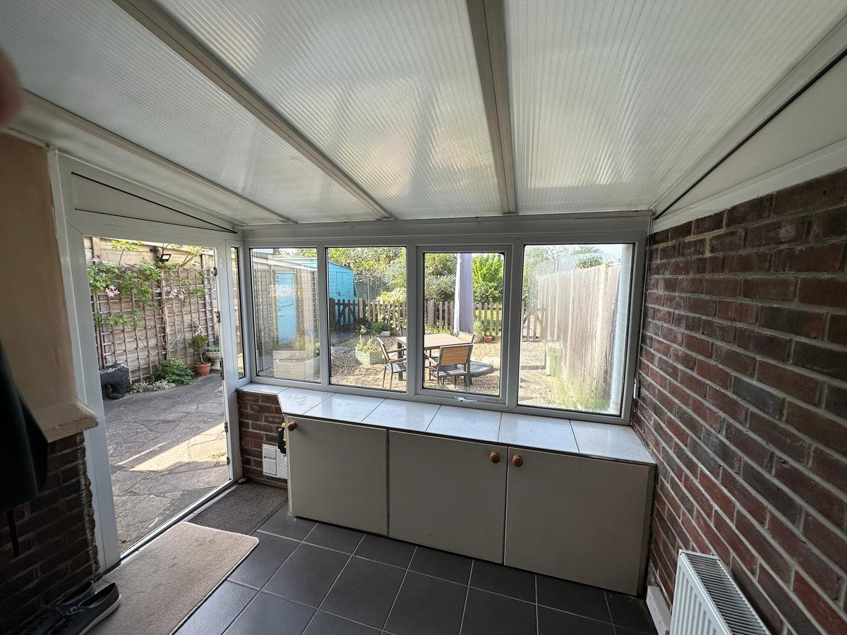 A polycarbonate conservatory roof with Supertint for Poly solar control window film applied to the roof for heat reduction.