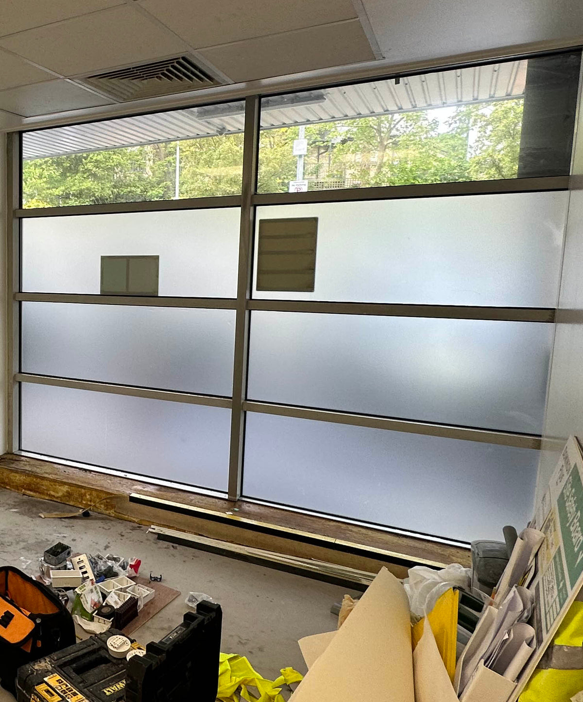 Internal view of a premises undergoing building work, with frosted window film from The Window Film Company applied to the glass to provide a temporary privacy solution. 