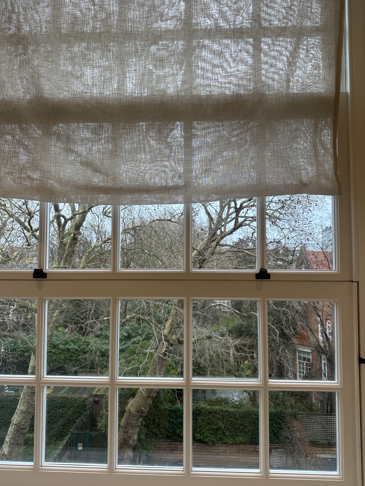 A close up of a window, which has lots of small panes, with uv filter protection window film applied to help reduce fading.