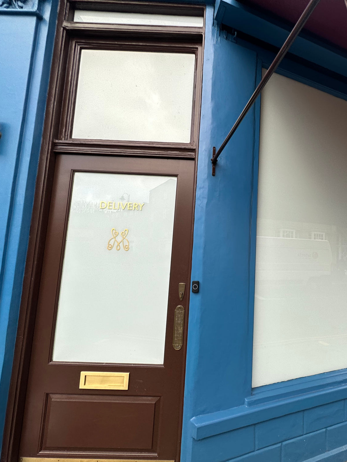A shopfront and door with whiteout white privacy window film applied to the glazing. 
