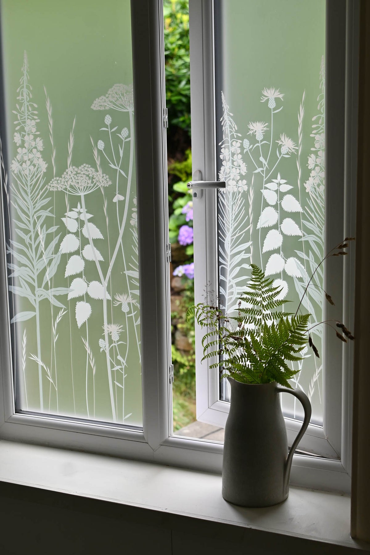 Etched privacy window film with a nature inspired floral design.