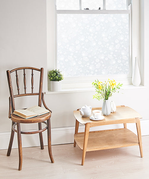 Interior of a home with a large window that has Helen Russell patterned window film applied to the glass. 
